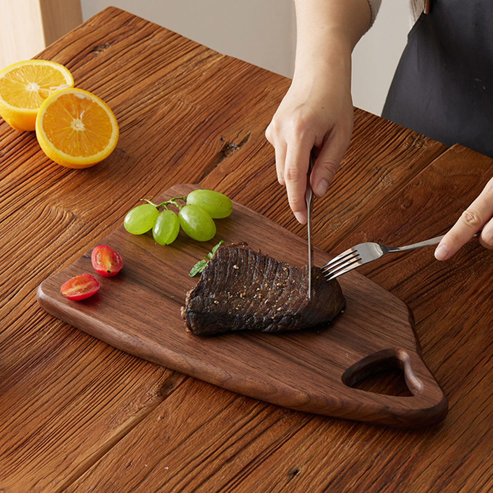 Black walnut steak cutting board with handle opening for restaurant serving